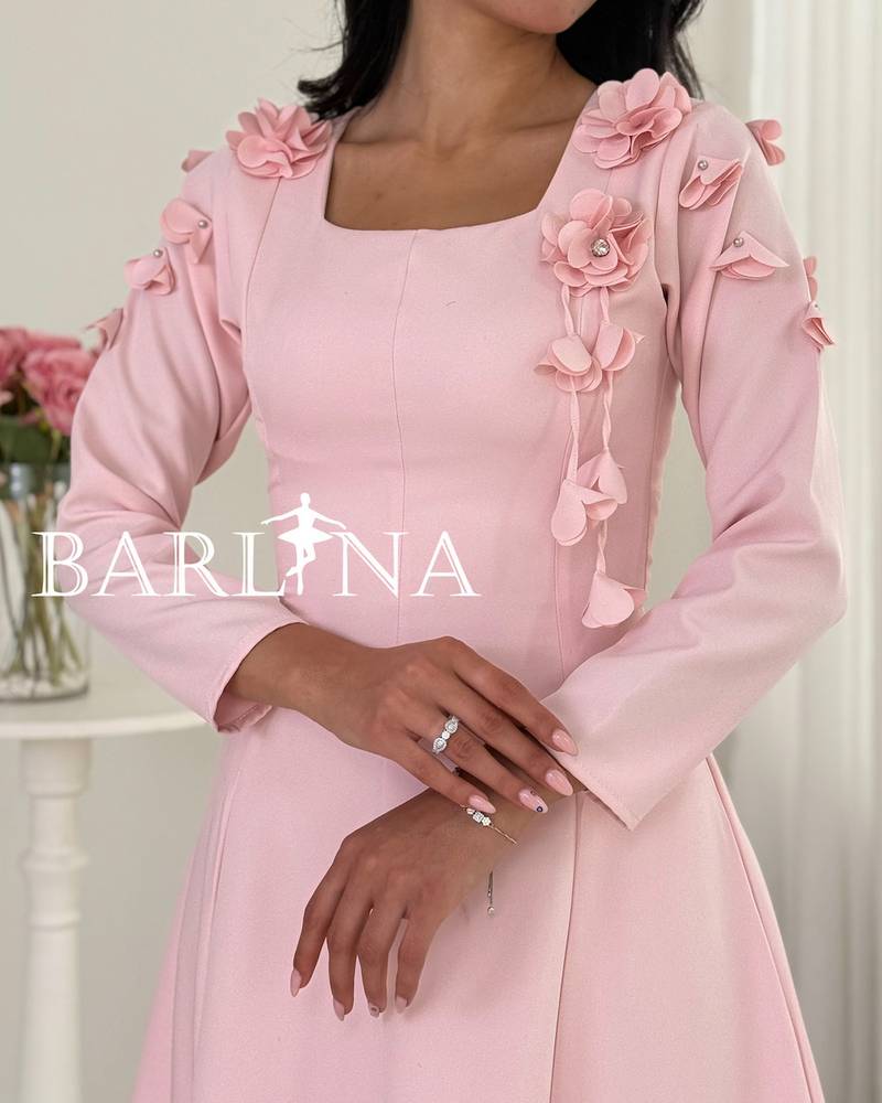 A soft pink midi dress with a sophisticated, feminine cut.