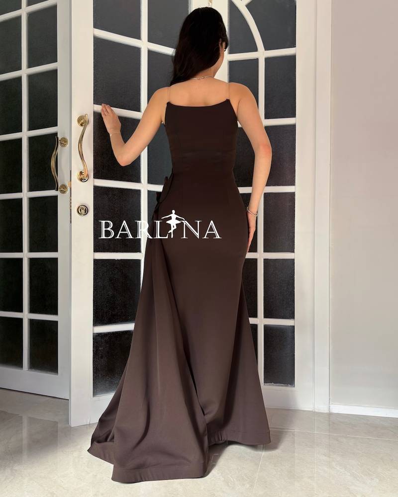 A brown dress with an elegant design and a flowing train