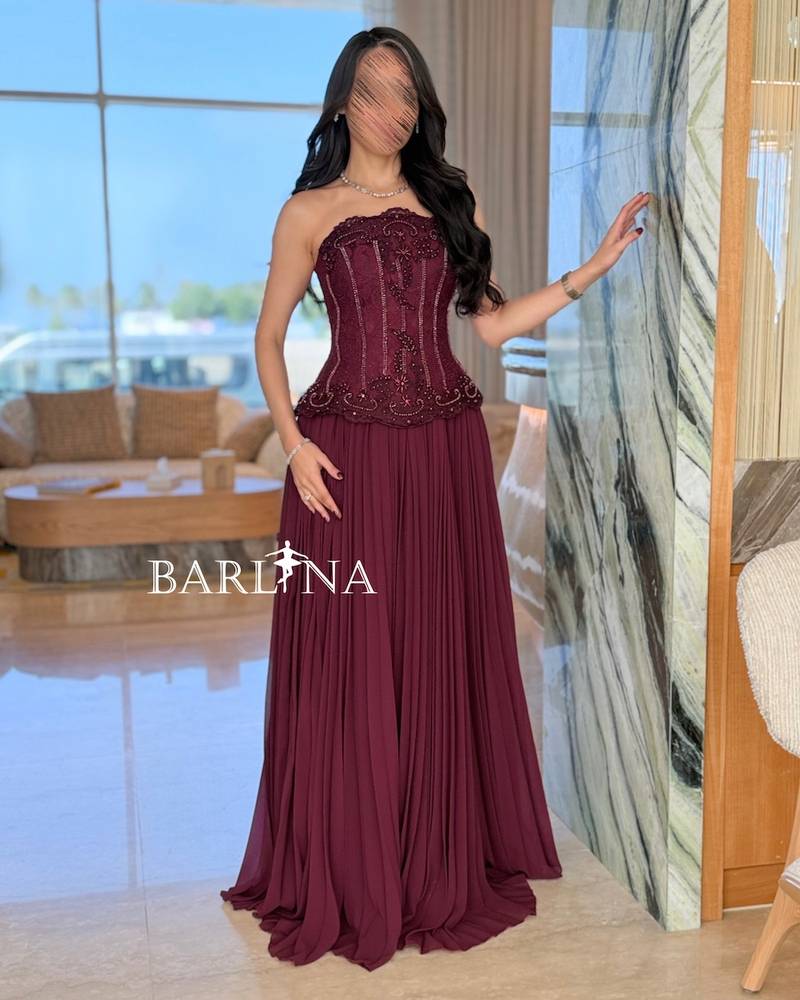 Burgundy dress with multiple pleats and a corset cut