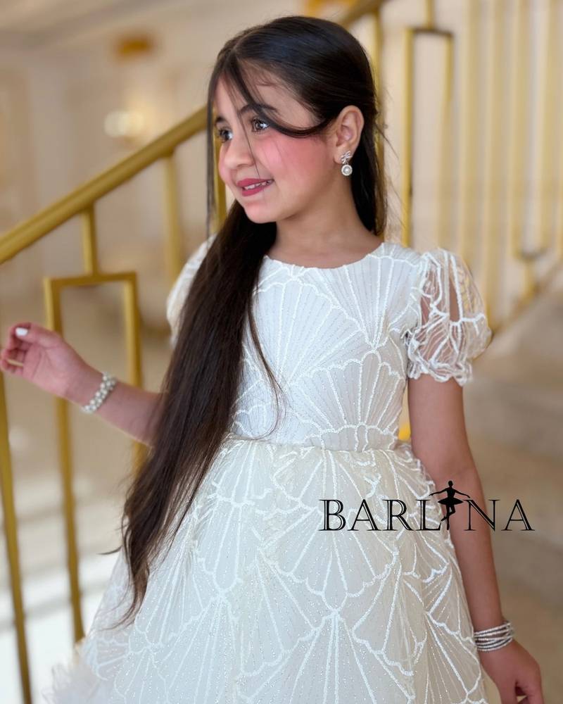 White patterned girl's dress with ruffled edges