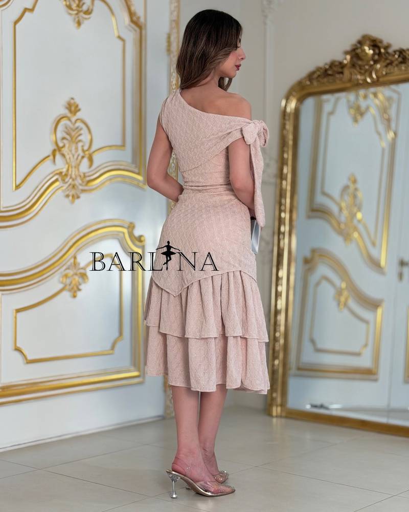 A soft dress with an elegant bow and layered details