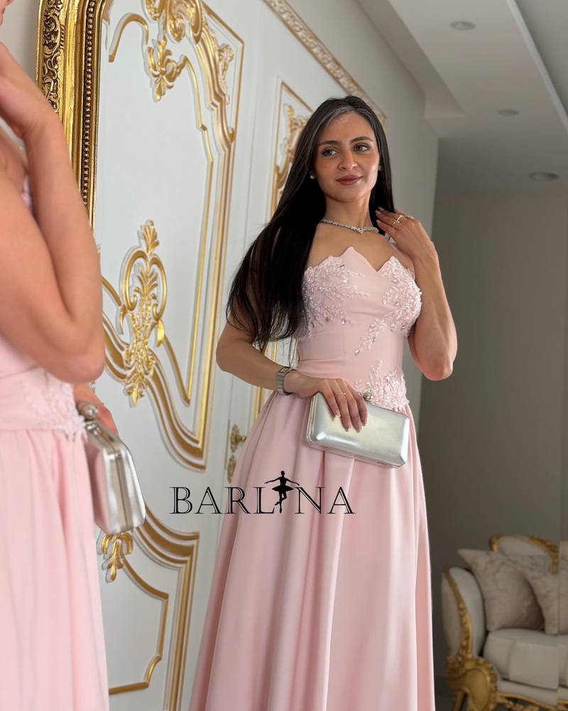 Pink sleeveless evening dress decorated with roses