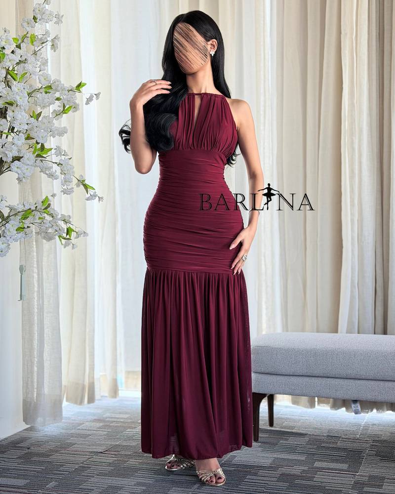 A fitted burgundy dress with soft pleats
