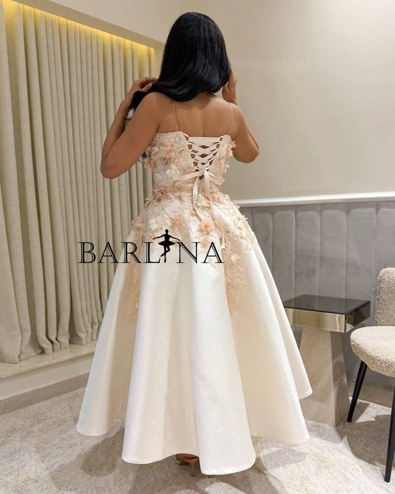 White dress with pink touches and soft flowers
