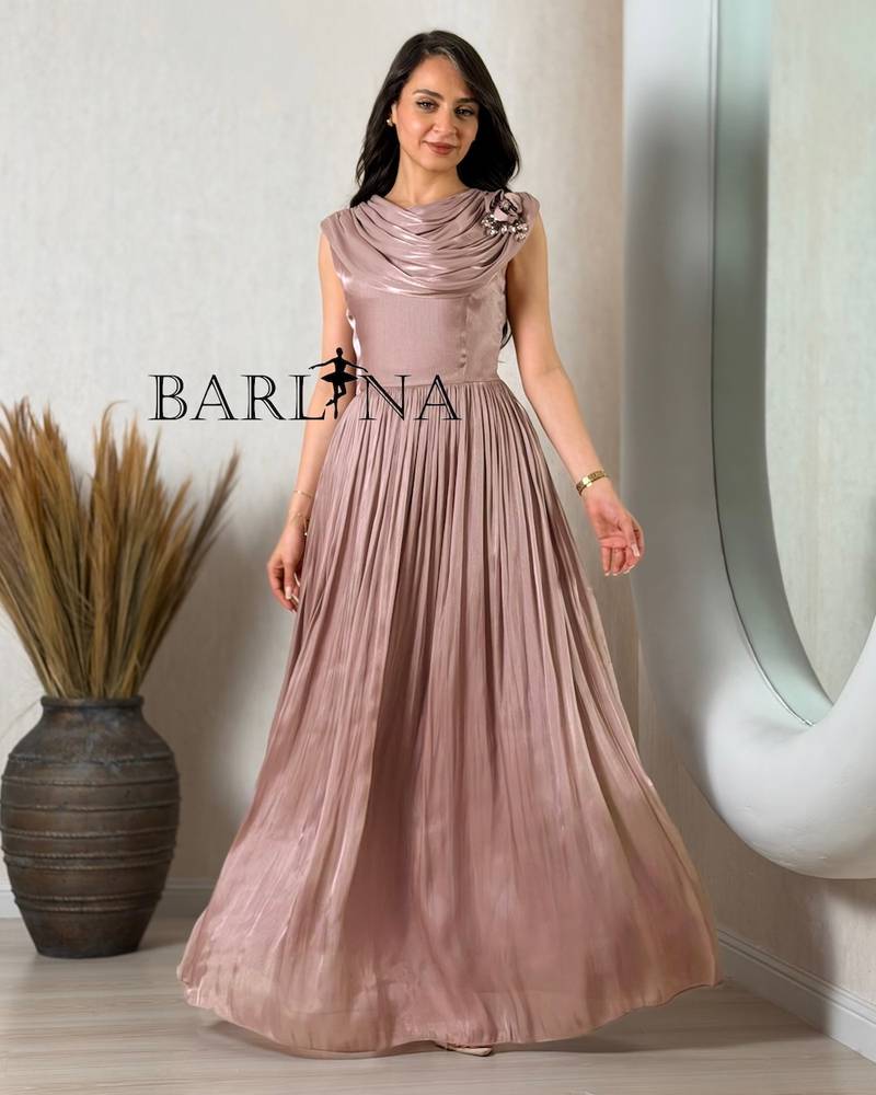 Elegant pink dress adorned with a rose and pleats
