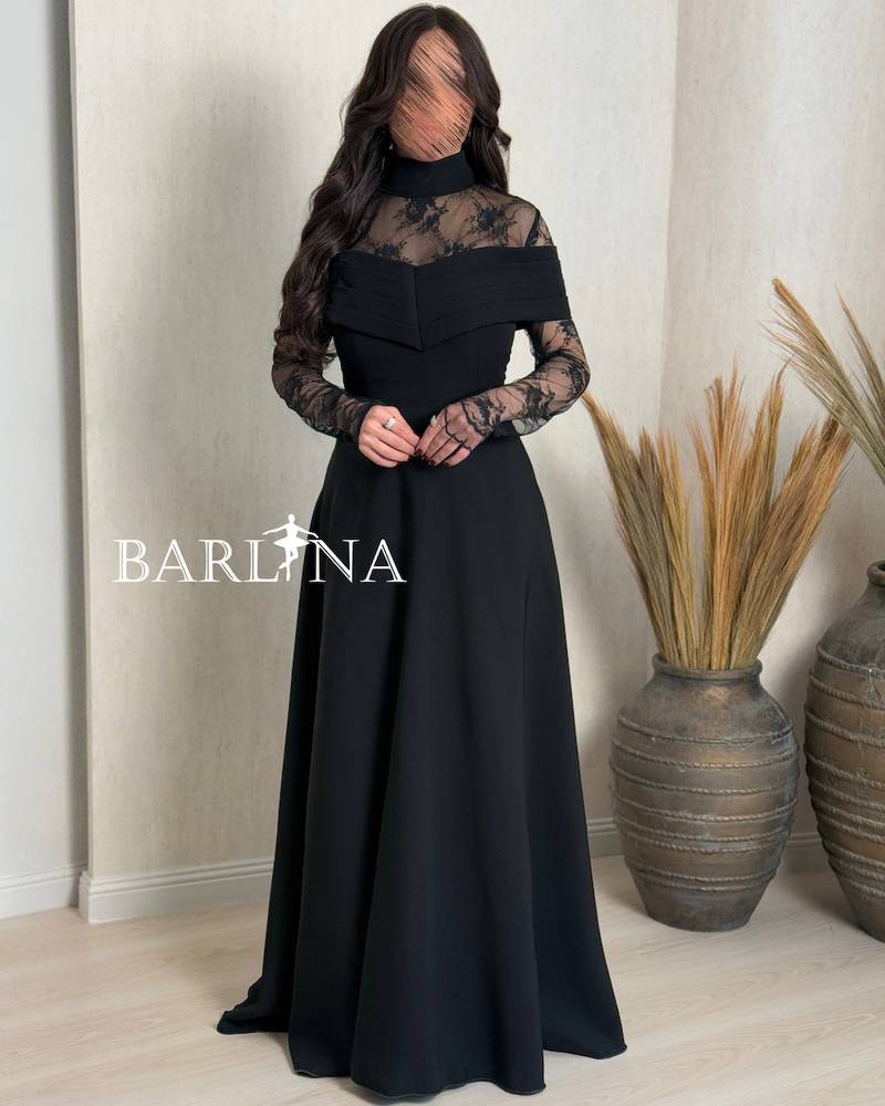 A soft black dress with sheer lace sleeves