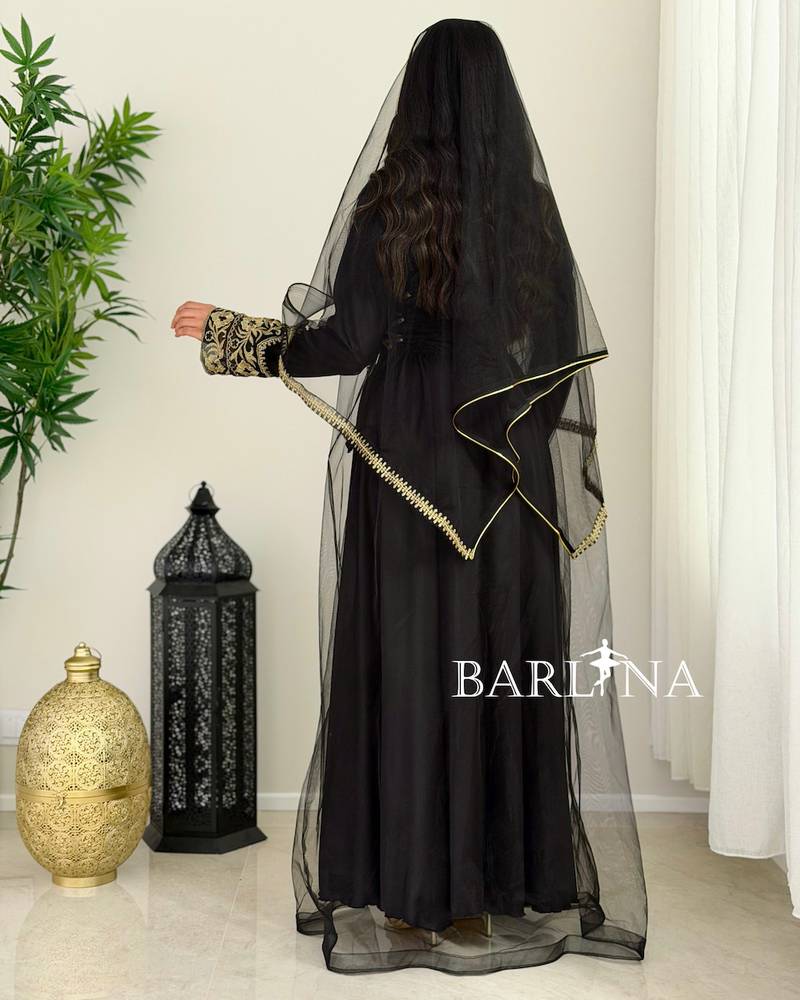 Black jalabiya with gold embroidery and a sheer headscarf