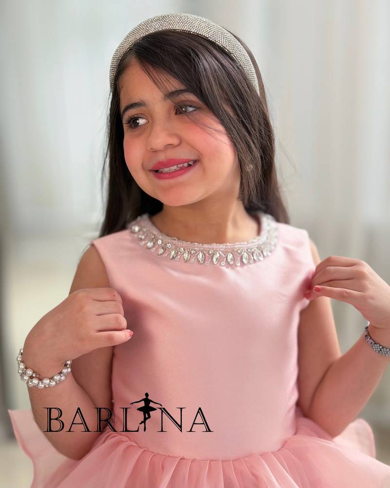 Pink layered girls' dress with a puffy cut