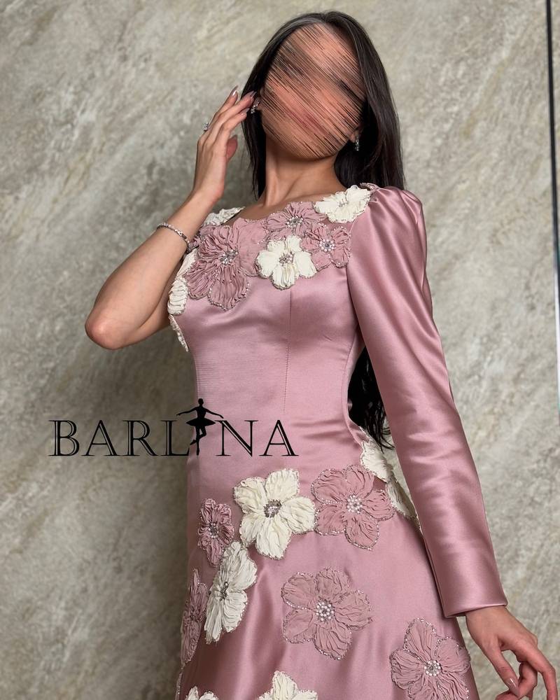 pink dress adorned with flowers and one long sleeve
