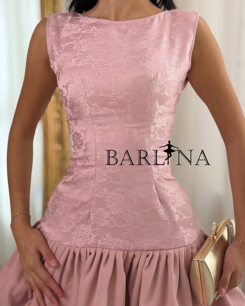 A soft dress with a low waist and layers of ruffles