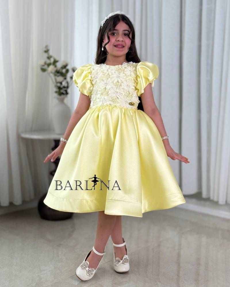 Yellow girl's dress with a bodice decorated with roses