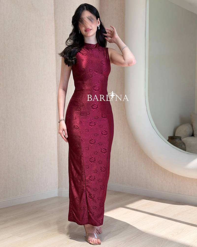 A simple, fitted burgundy dress with a subtle pattern