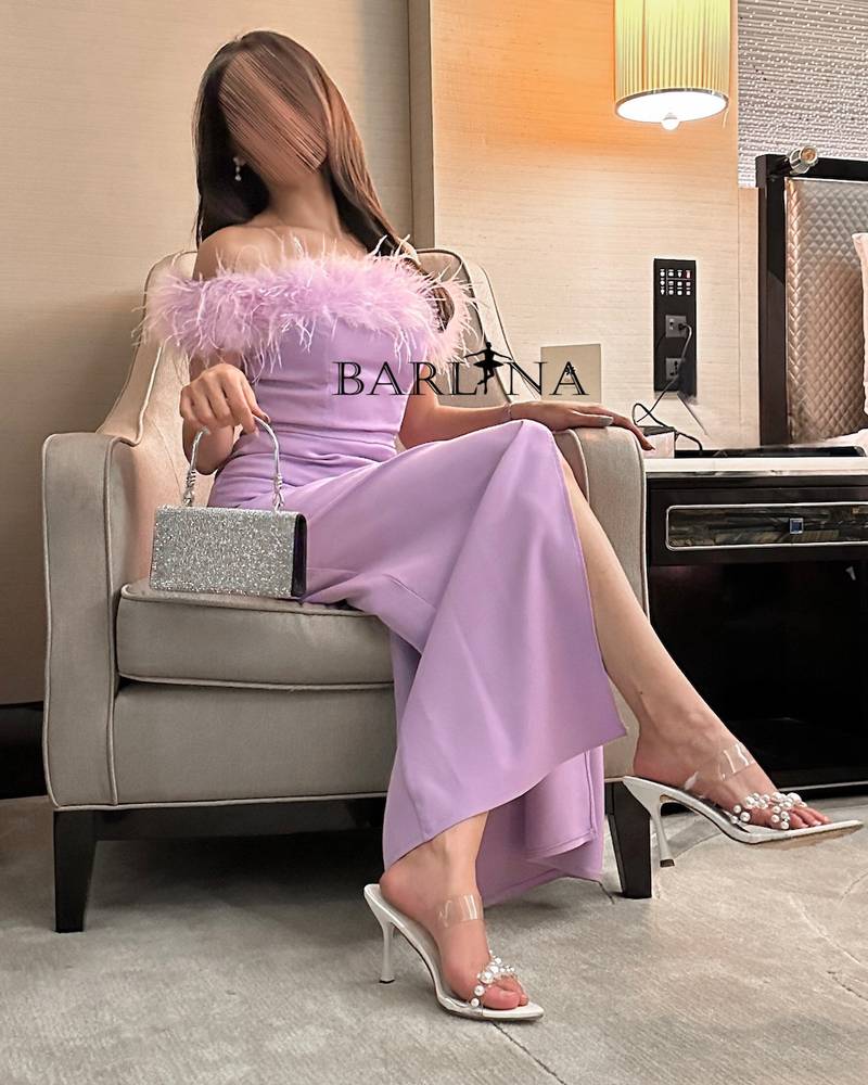 Long purple dress with off-shoulder feathers