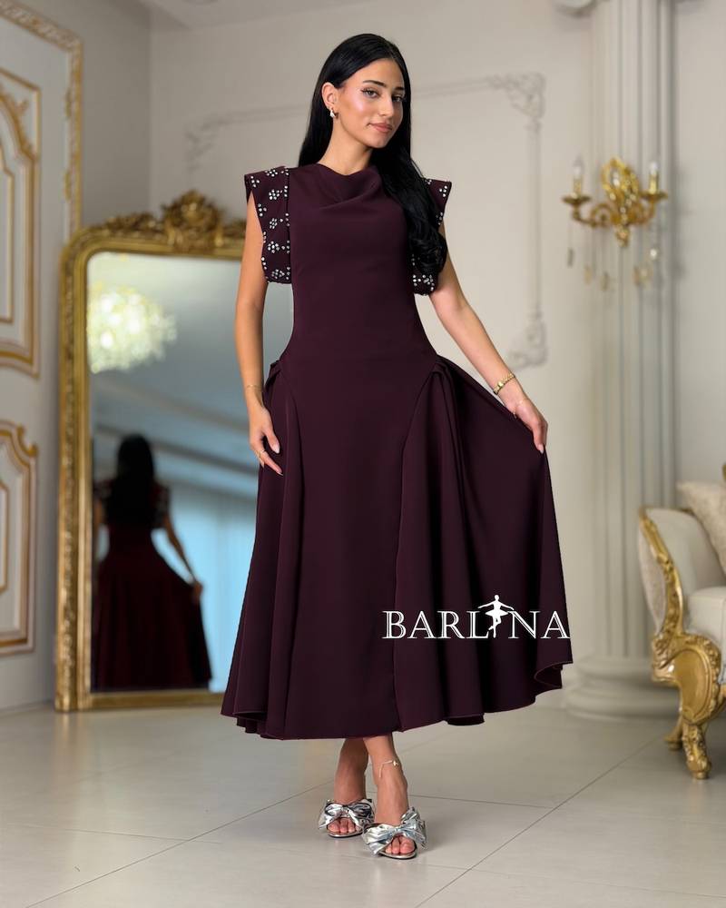 Maroon dress with embroidered shoulders and a flared silhouette