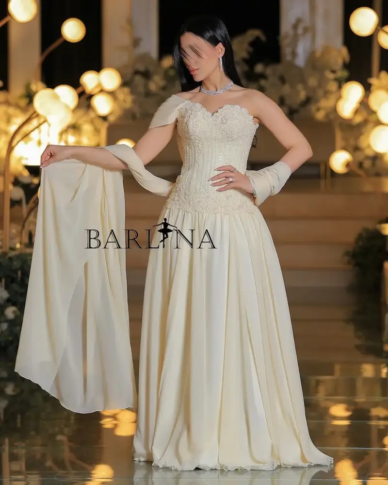 Royal ivory evening gown with draped sleeves