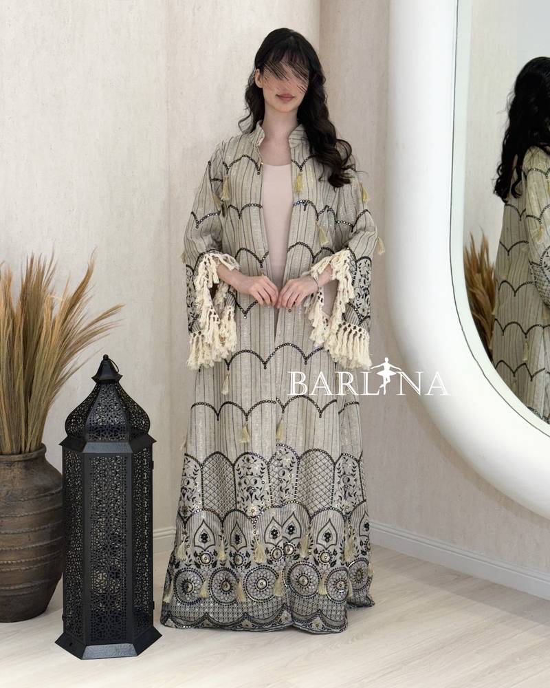 A jalabiya with a geometric pattern in shades of beige and black.