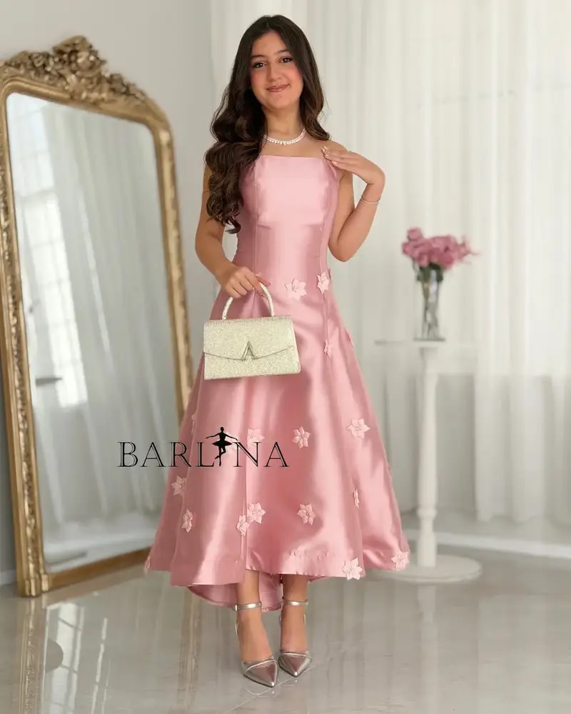 A pink dress with floral details for the age-confusing occasion.