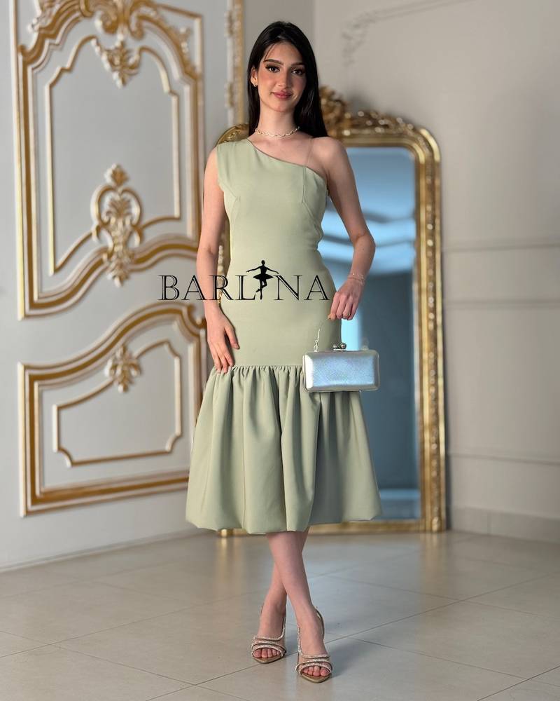 Light green one-shoulder dress with a ruffled hem