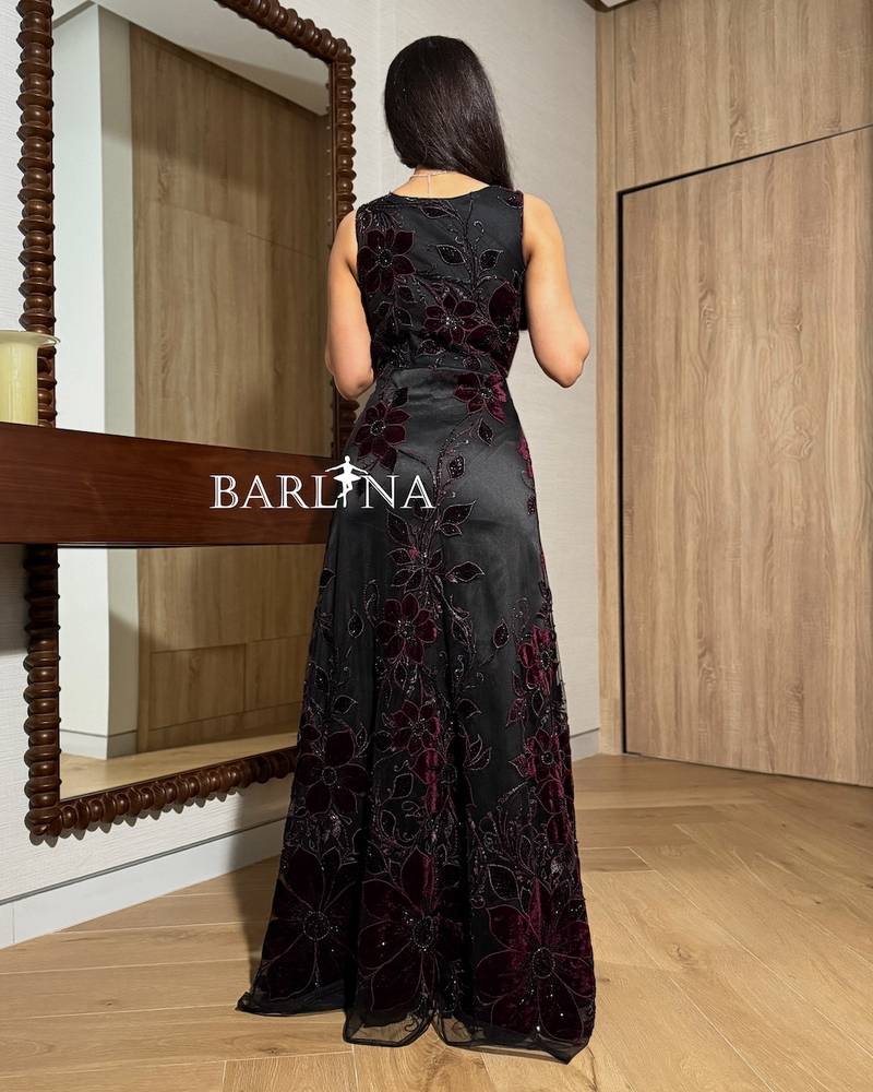A black dress adorned with burgundy velvet flowers