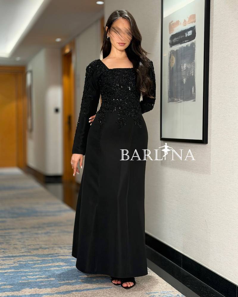 Black dress with luxurious embroidery and long sleeves