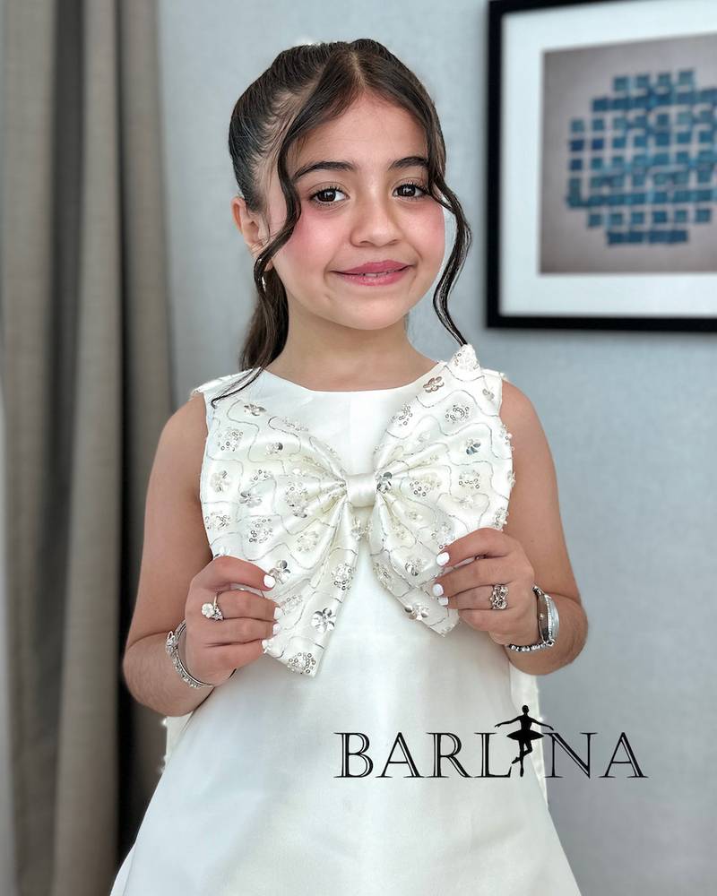Girls' white dress with a large embroidered bow