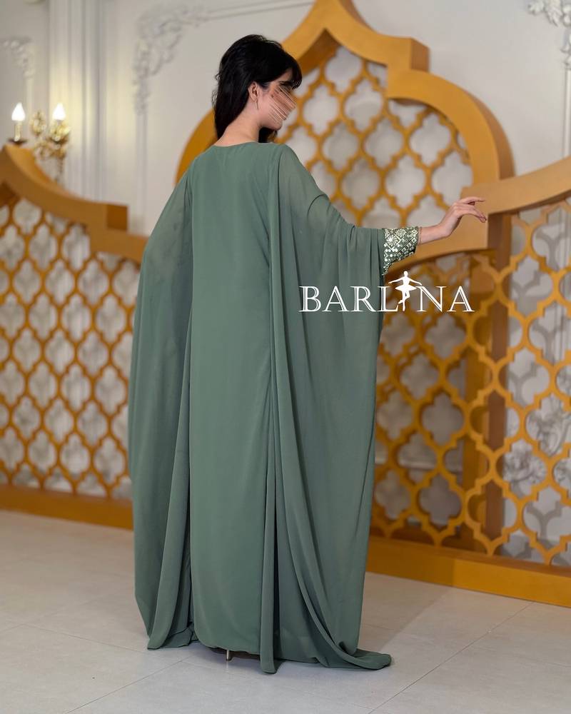 Green jalabiya embroidered with a traditional design
