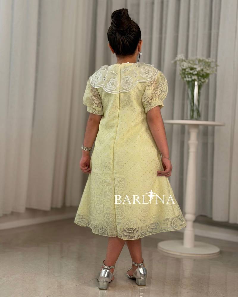 A yellow girl's dress with elegant and sophisticated details