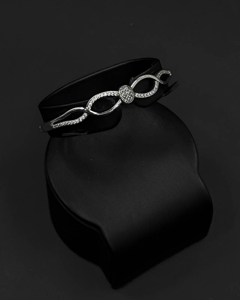 Elegant silver bracelet and ring with flowing lines