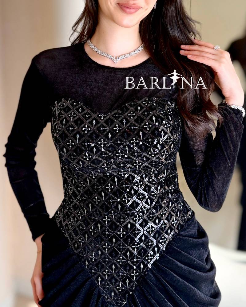 A black velvet dress with a sophisticated sheen and draping.