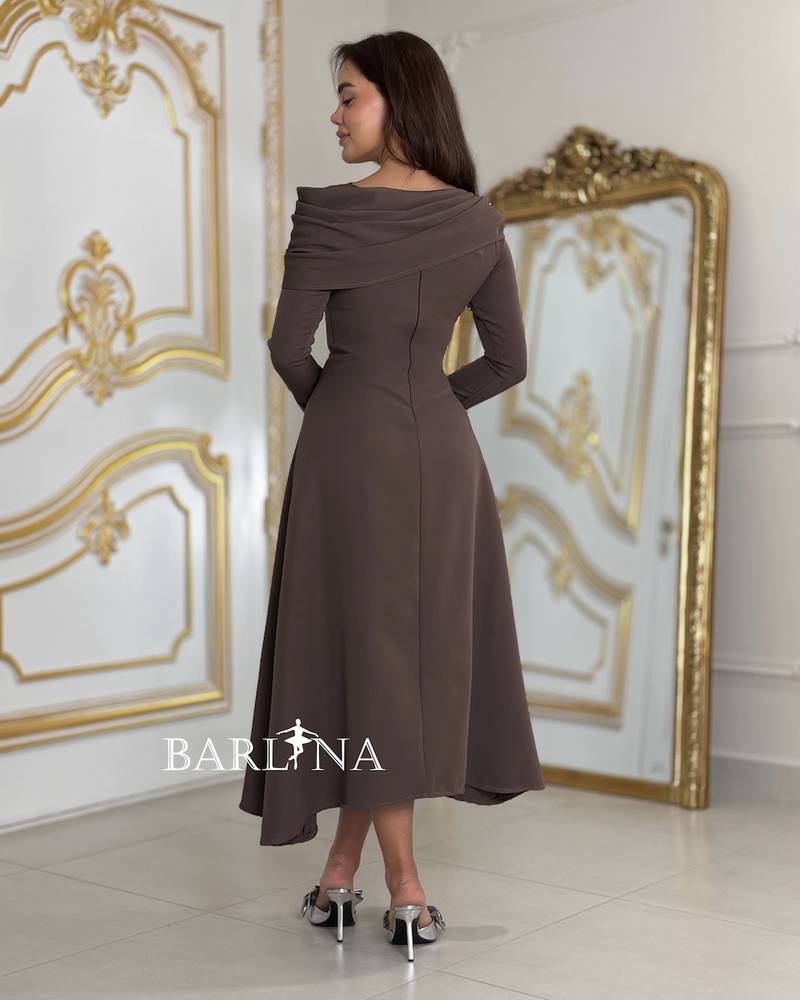 A dress with a modern, elegant cut and side buttons.