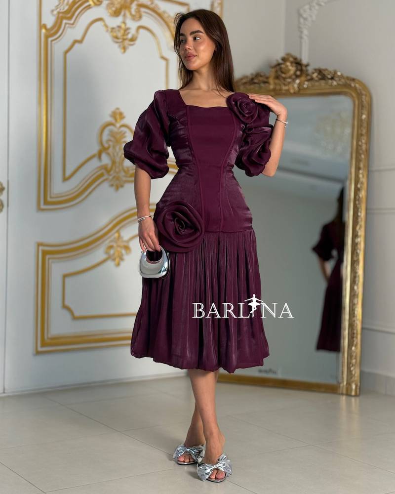 A purple dress adorned with roses and a touch of pleats