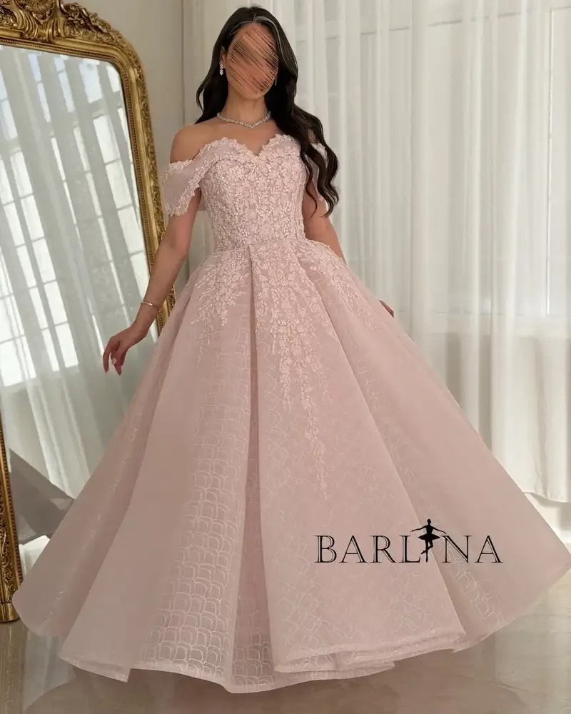 A pink puffy evening dress adorned with delicate embroidery