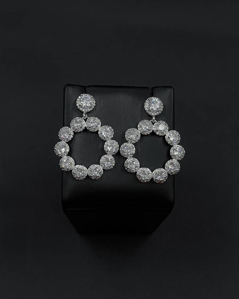 Round evening earrings studded with crystals