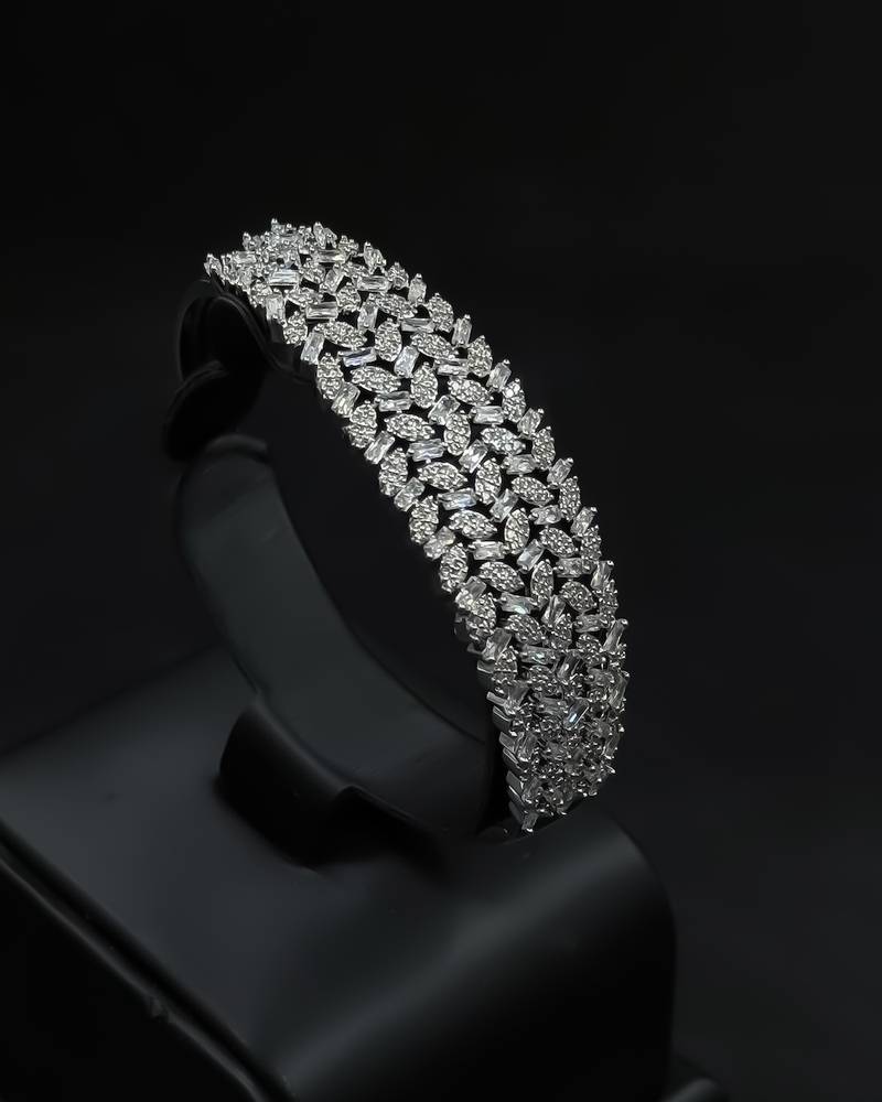 A wide bracelet and ring with intricate details