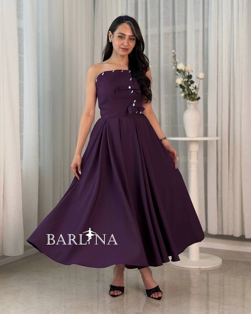 A purple dress with a simple cut and side details.