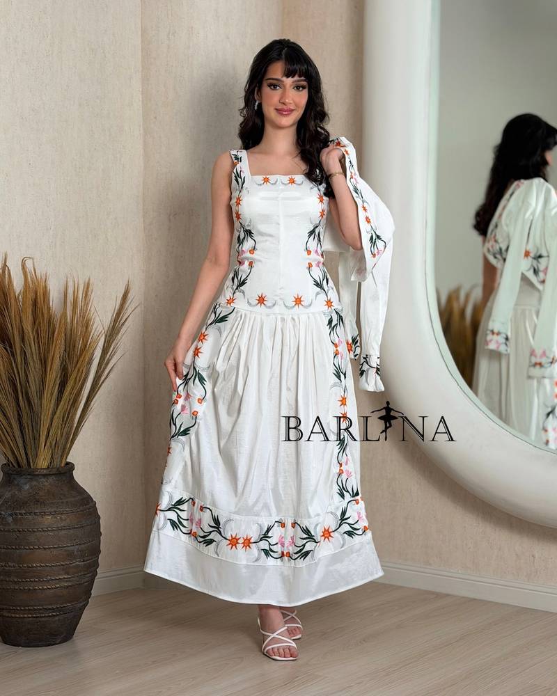 A soft white dress with colorful floral embroidery