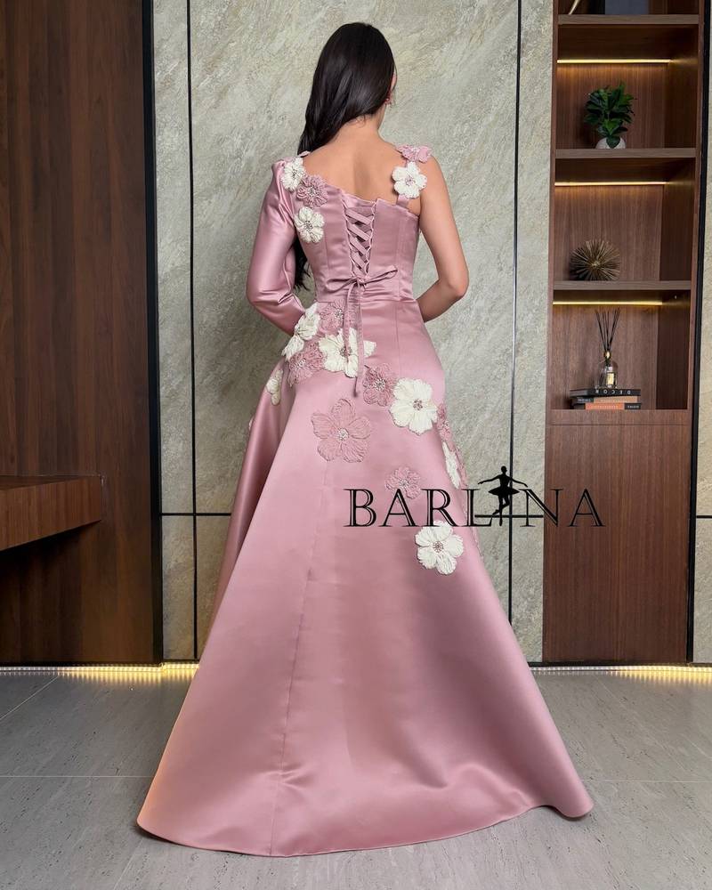 pink dress adorned with flowers and one long sleeve