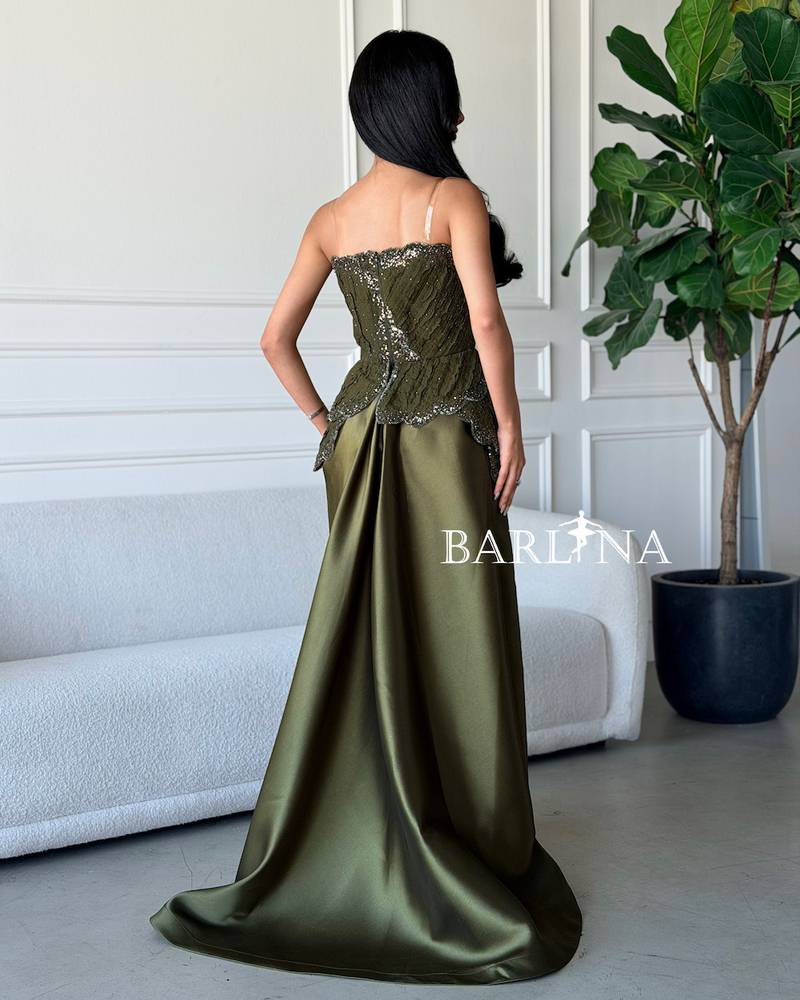 Olive green dress with layered embroidery and a prominent design