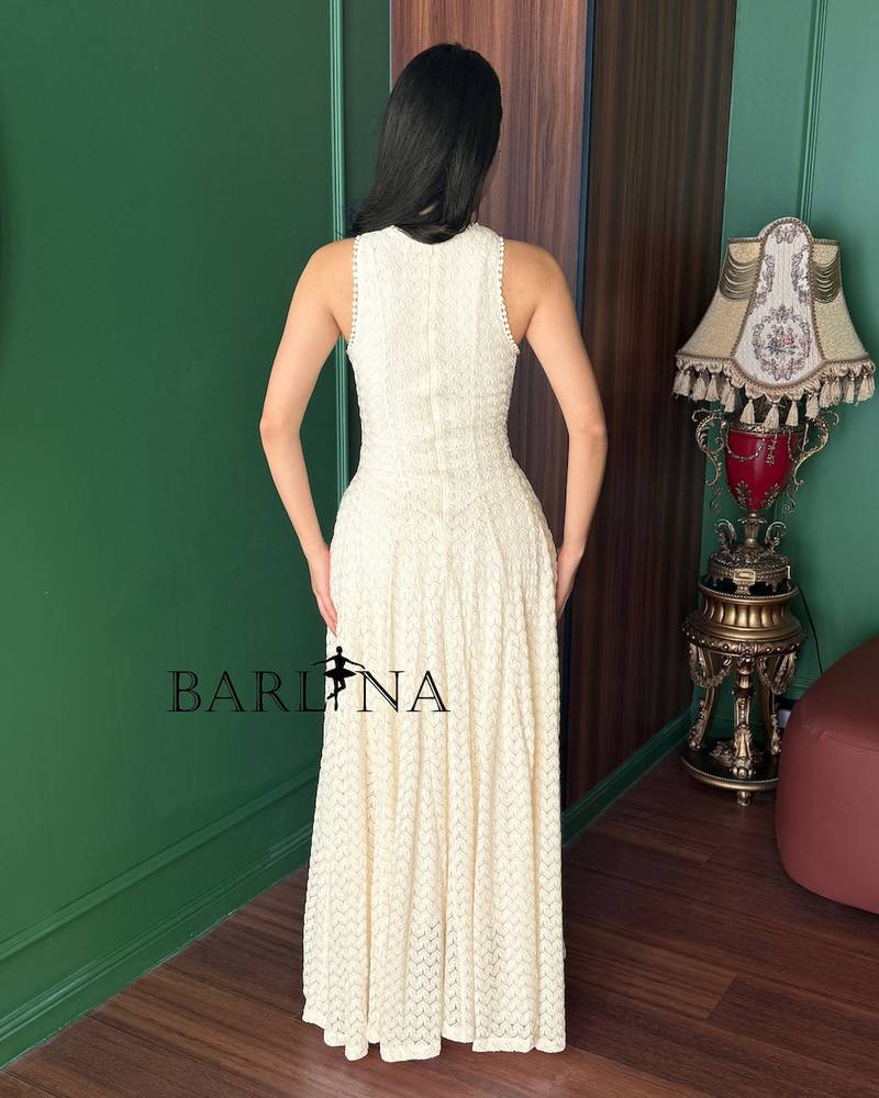 Soft off-white sleeveless dress with a flowing silhouette