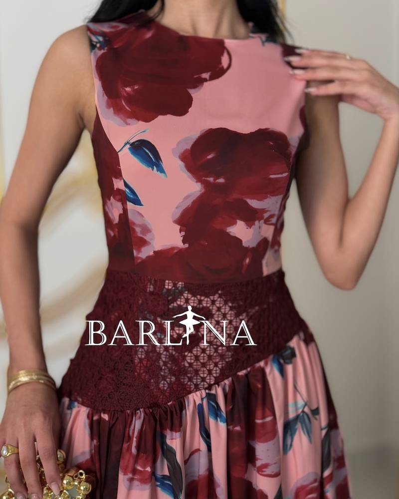 A stylish pink dress with red floral accents