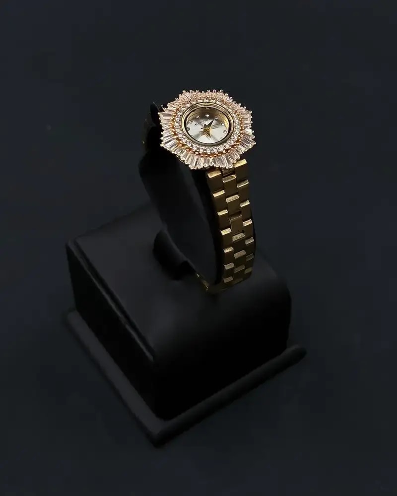 Elegant women's watch with a round studded bezel