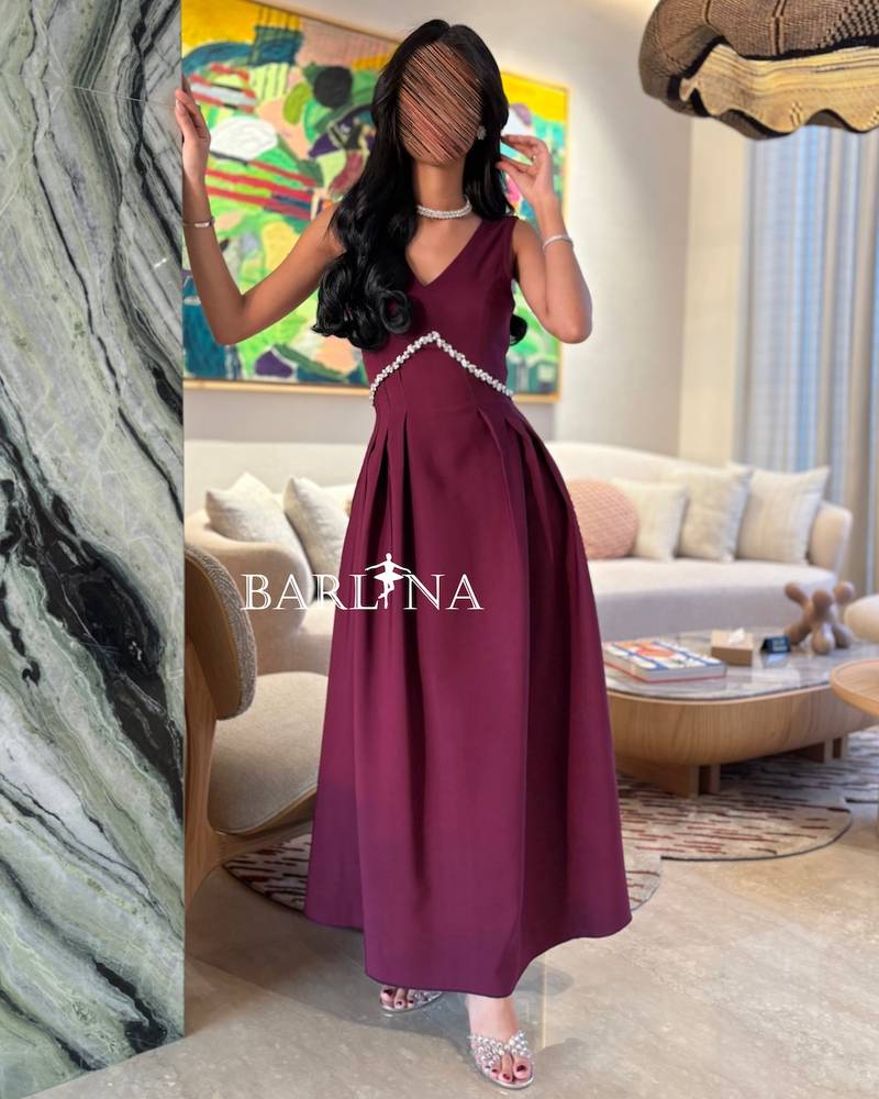 berry-toned dress adorned with a crystal curve