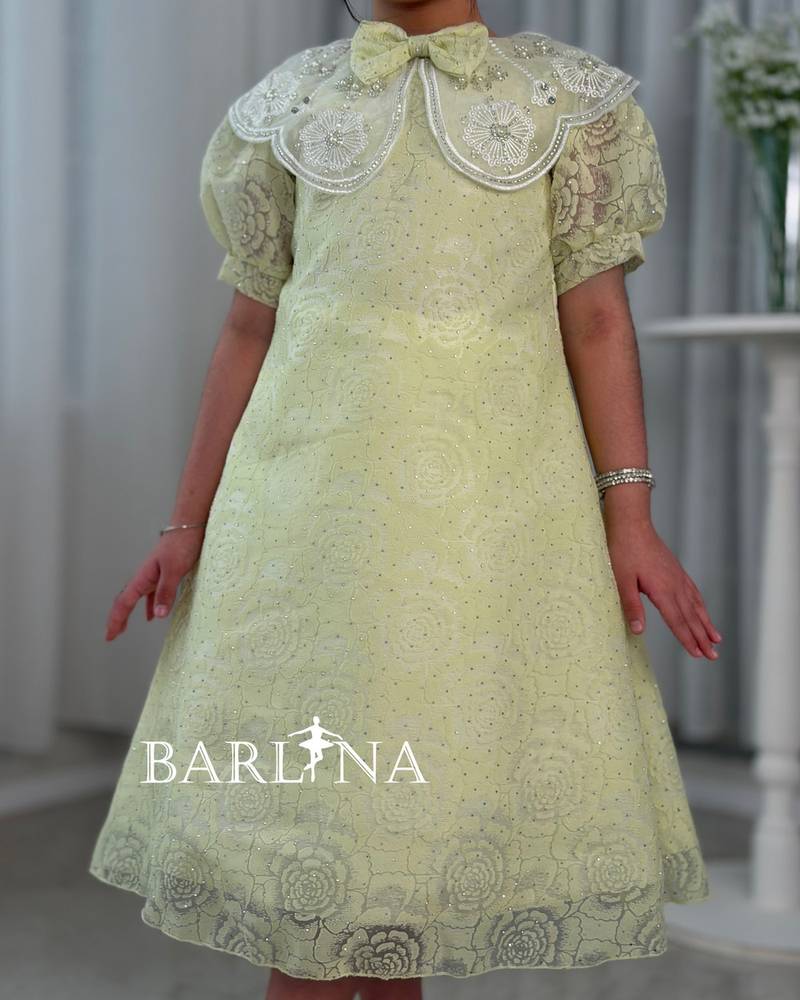 A yellow girl's dress with elegant and sophisticated details