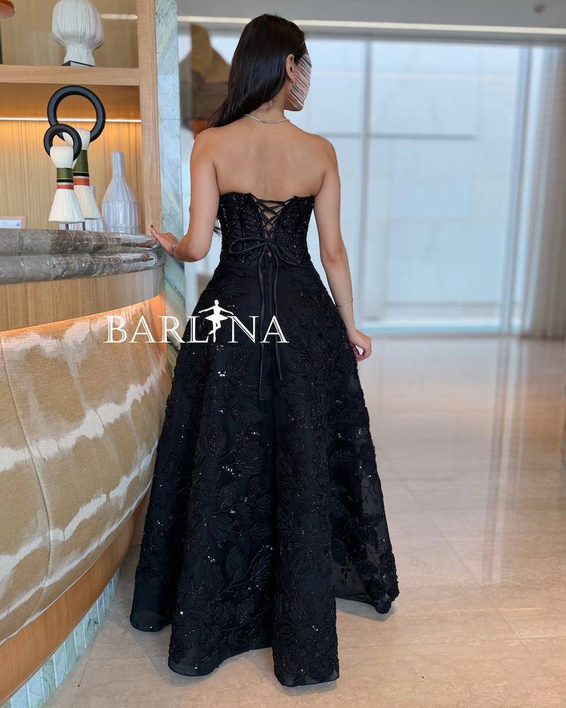 A puffy evening dress with shiny black embroidery