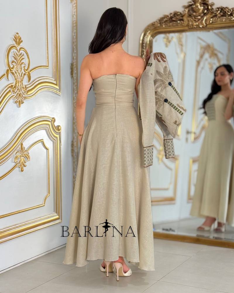Beige dress with a jacket embroidered with palm trees