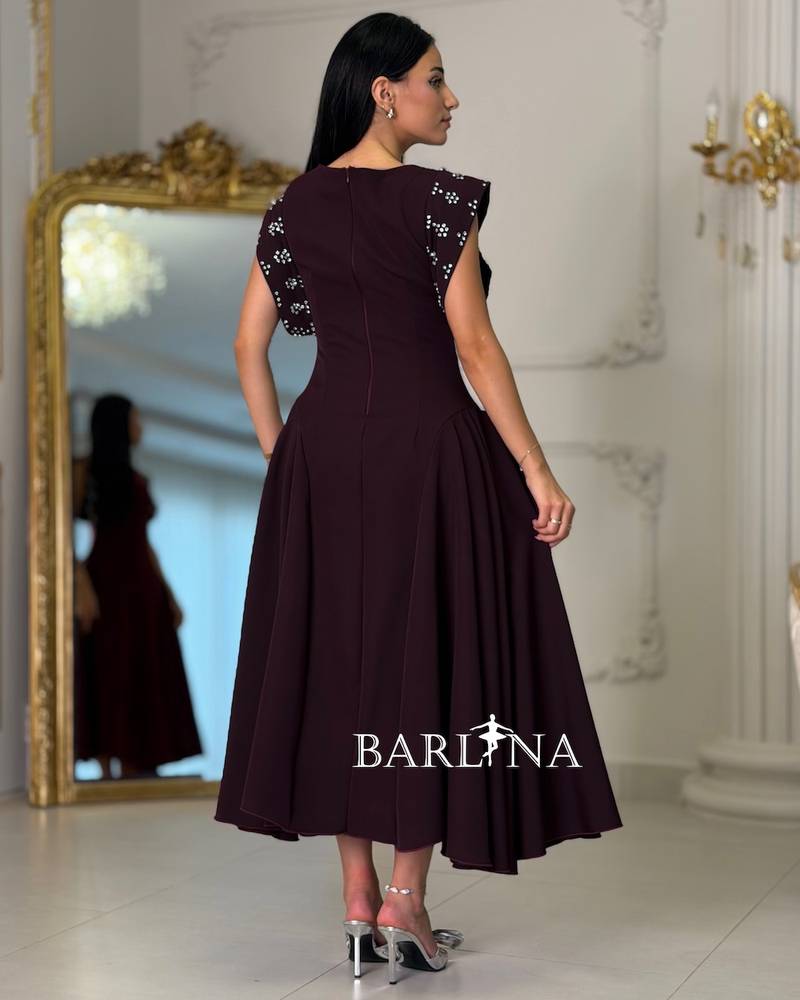 Maroon dress with embroidered shoulders and a flared silhouette
