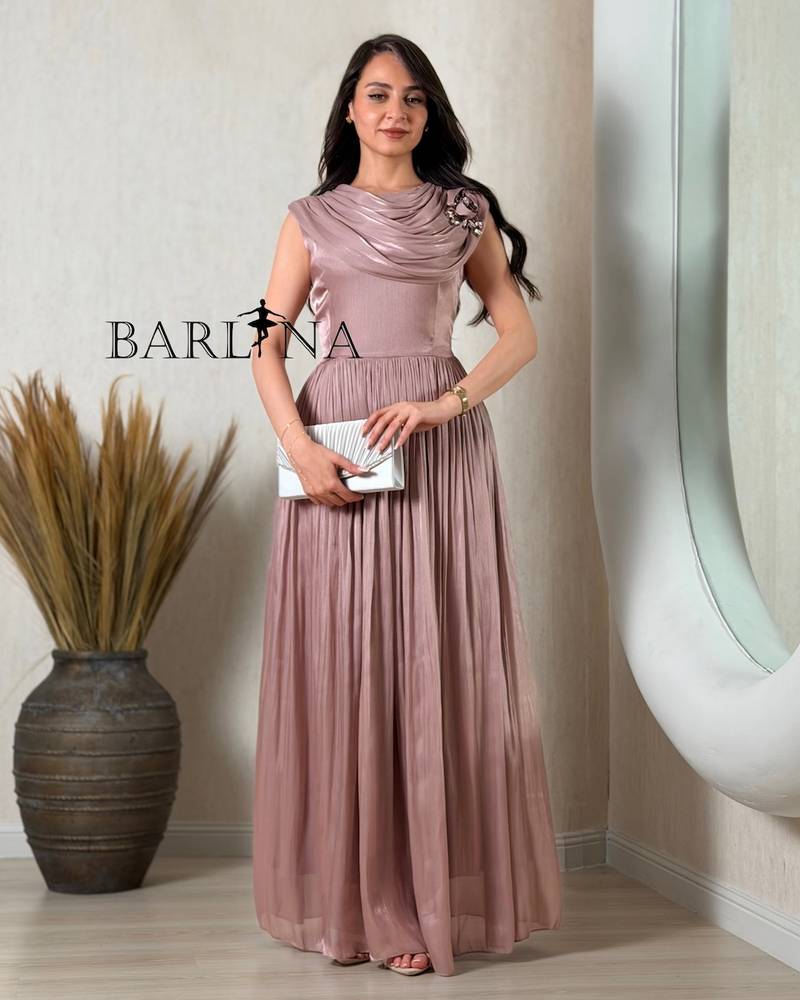 Elegant pink dress adorned with a rose and pleats