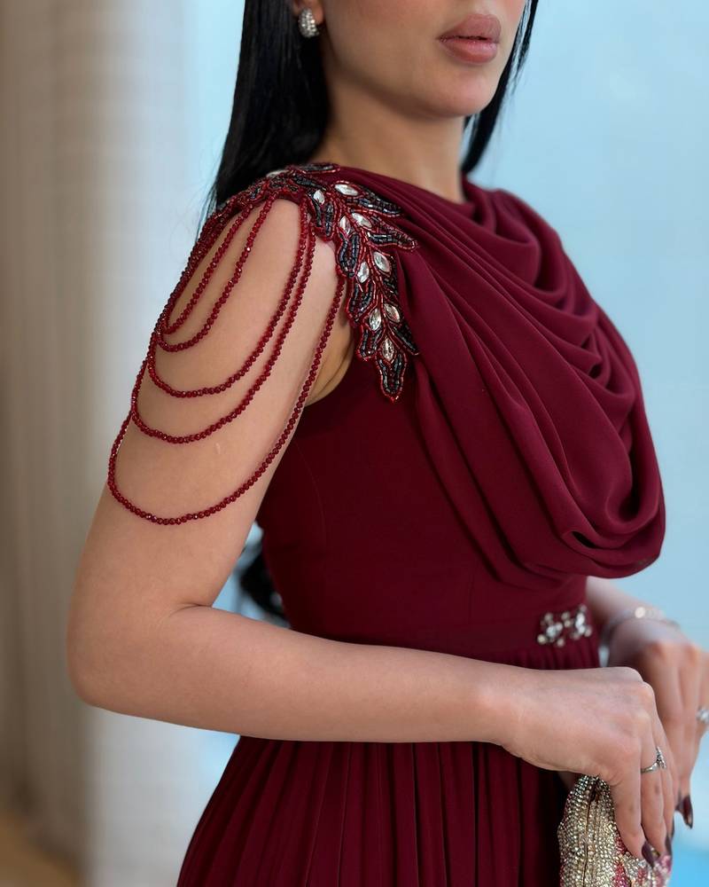 Long burgundy pleated dress with a draped collar