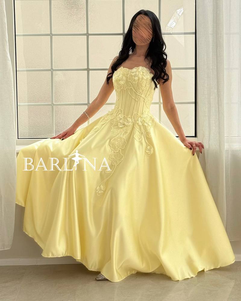 Light yellow evening dress with an embroidered corset cut