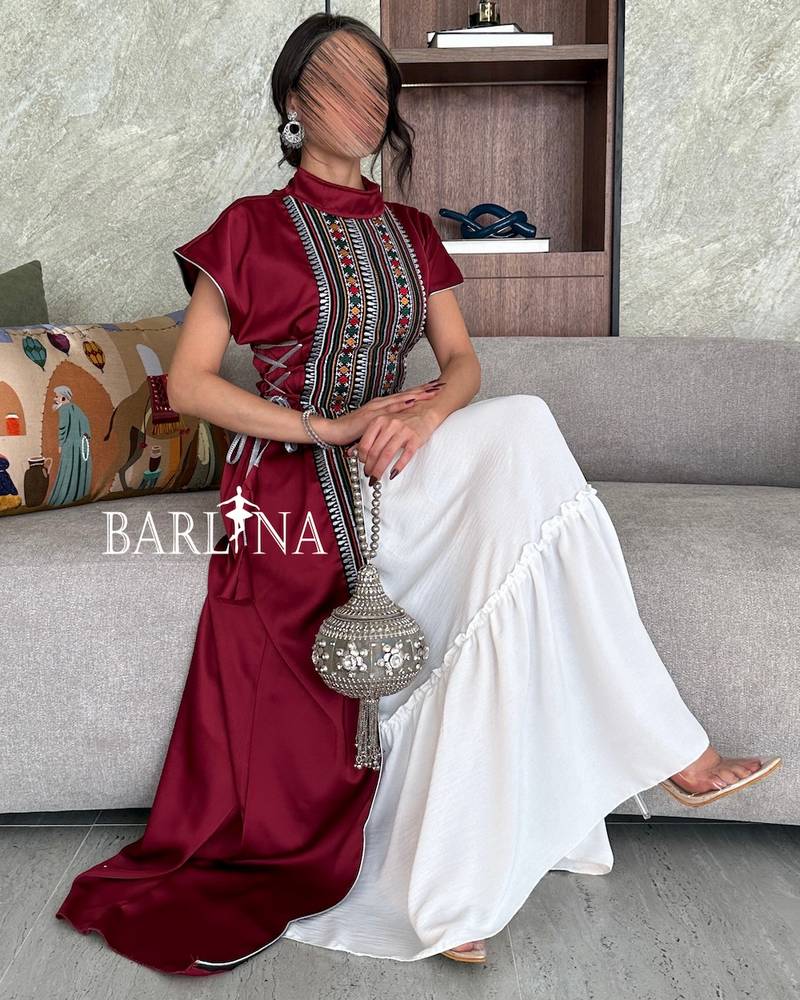 Maroon jalabiya decorated with Sadu patterns